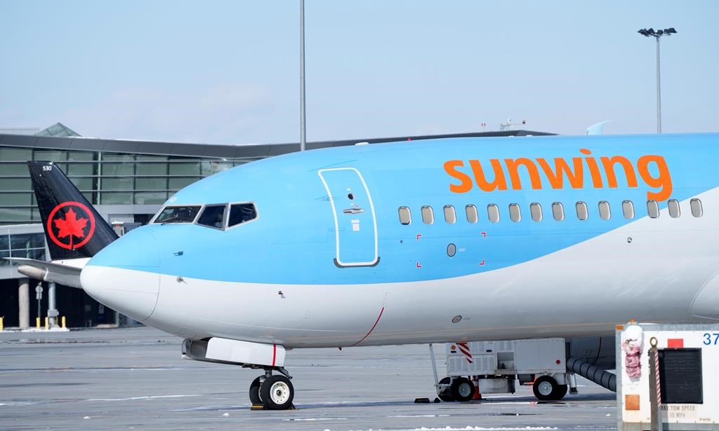 A Sunwing aircraft is parked at Montreal Trudeau airport in Montreal on Wednesday, March 2, 2022. WestJet says it aims to wind down Sunwing Airlines and integrate the low-cost carrier into its mainline business by October of next year.